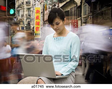 young woman on a laptop View Large Photo Image Stock Photography - young woman on a laptop. Fotosearch