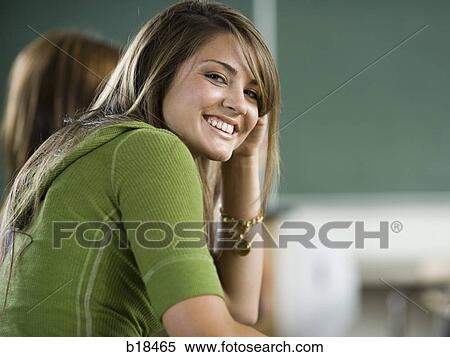 Young woman sitting in a classroom. View Large Photo Image Stock Photography - Young woman sitting in a classroom.. Fotosearch