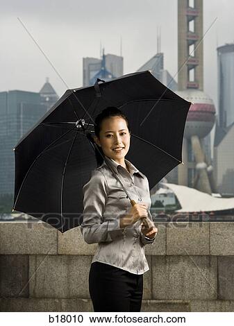 Young woman under an umbrella. View Large Photo Image Stock Image - Young woman under an umbrella.. Fotosearch