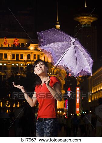 Stock Photo - Young woman under an umbrella.. Fotosearch