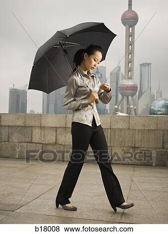 Young woman under an umbrella. View Large Photo Image Stock Photo - Young woman under an umbrella.. Fotosearch