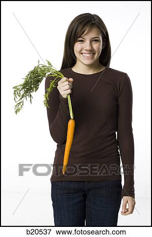 young woman with a carrot View Large Photo Image Stock Photo - young woman with a carrot. Fotosearch