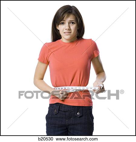 Stock Image - young woman with a measuring tape. Fotosearch