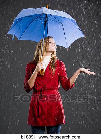 Young woman with an umbrella. View Large Photo Image Stock Image - Young woman with an umbrella.. Fotosearch