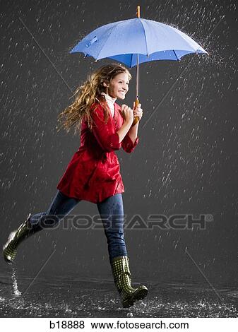 Stock Photo - Young woman with an umbrella.. Fotosearch
