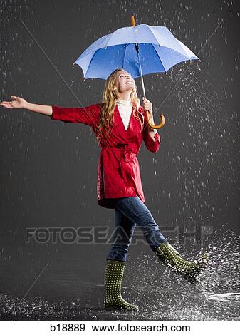 Young woman with an umbrella. View Large Photo Image Stock Photo - Young woman with an umbrella.. Fotosearch