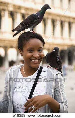 Young woman with birds on her head and shoulder. View Large Photo Image Stock Photo - Young woman with birds on her head and shoulder.. Fotosearch