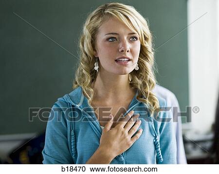 Young woman with hand over heart. View Large Photo Image Stock Image - Young woman with hand over heart.. Fotosearch