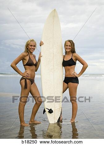 Young women and surfboard at the beach. View Large Photo Image Stock Image - Young women and surfboard at the beach.. Fotosearch