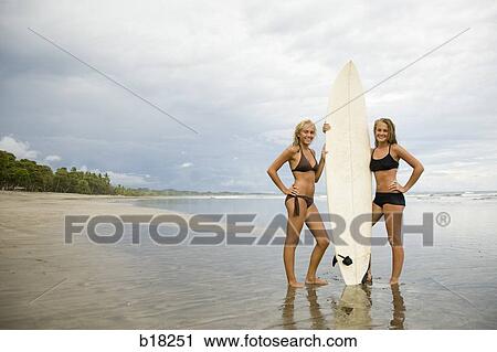 Young women and surfboard at the beach. View Large Photo Image Stock Image - Young women and surfboard at the beach.. Fotosearch