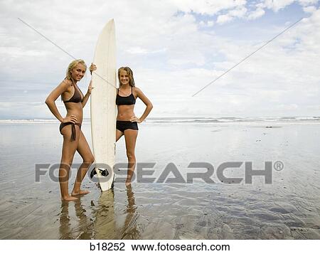 Young women and surfboard at the beach. View Large Photo Image Stock Image - Young women and surfboard at the beach.. Fotosearch