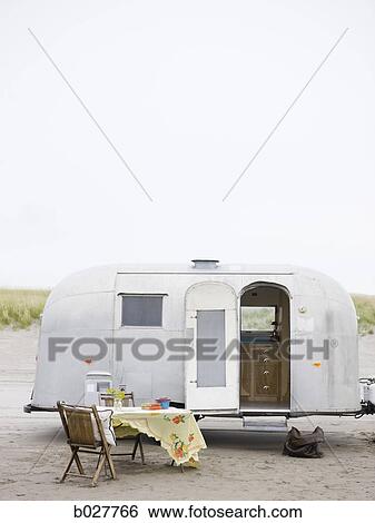 airstream classic trailer with a table set up in front of it on the sand View Large Photo Image Stock Photograph - airstream classic trailer with a table set up in front of it on the sand. Fotosearch