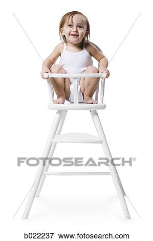 baby girl in a high chair View Large Photo Image Stock Photo - baby girl in a high chair. Fotosearch