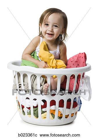 Stock Image - baby girl in a laundry basket. Fotosearch