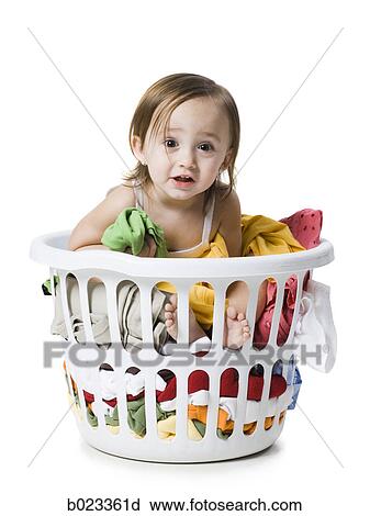 Stock Image - baby girl in a laundry basket. Fotosearch