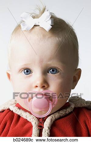 Stock Image - baby girl in a red coat. Fotosearch