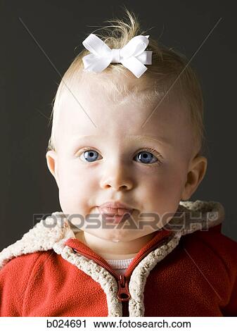 Stock Image - baby girl in a red coat. Fotosearch