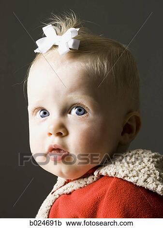 Stock Image - baby girl in a red coat. Fotosearch