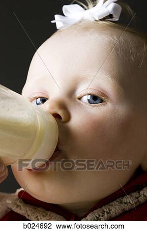 Stock Image - baby girl in a red coat. Fotosearch