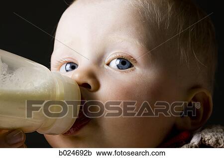 Stock Image - baby girl in a red coat. Fotosearch