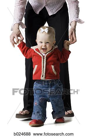 Stock Photo - baby girl in a red coat. Fotosearch