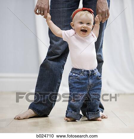 Stock Image - baby girl learning to walk. Fotosearch