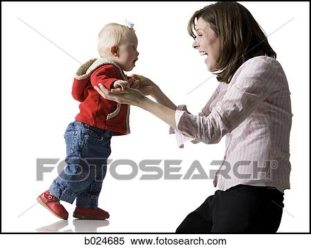 Stock Photography - baby girl learning to walk. Fotosearch
