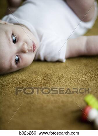 baby girl lying on the carpet View Large Photo Image Stock Photograph - baby girl lying on the carpet. Fotosearch