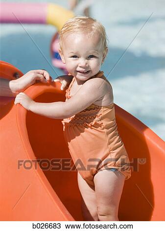 baby girl playing on a waterslide View Large Photo Image Stock Image - baby girl playing on a waterslide. Fotosearch