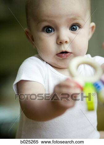 Stock Photography - baby girl playing with a toy. Fotosearch