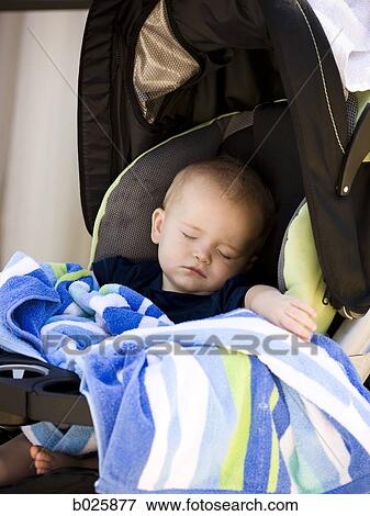 Stock Photo - baby sleeping in stroller. Fotosearch