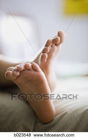 bare feet hanging off the bed View Large Photo Image Stock Photo - bare feet hanging off the bed. Fotosearch