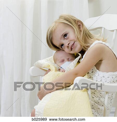 big sister holding her newborn brother View Large Photo Image Stock Photo - big sister holding her newborn brother. Fotosearch