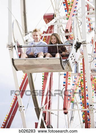 boy and girl on a ferris wheel View Large Photo Image Stock Image - boy and girl on a ferris wheel. Fotosearch
