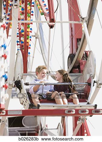 boy and girl on a ferris wheel View Large Photo Image Stock Image - boy and girl on a ferris wheel. Fotosearch