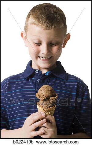 boy holding an ice cream cone View Large Photo Image Stock Image - boy holding an ice cream cone. Fotosearch