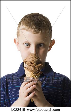 Stock Photo - boy holding an ice cream cone. Fotosearch