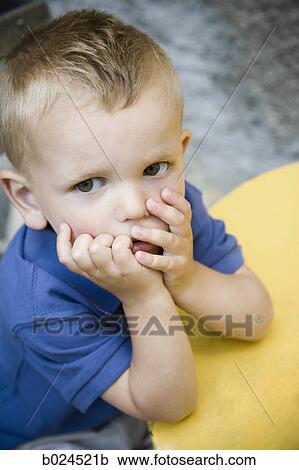 Stock Image - boy in a blue shirt. Fotosearch