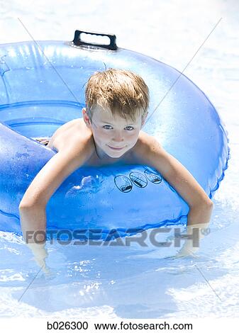 Stock Image - boy in an inner tube. Fotosearch