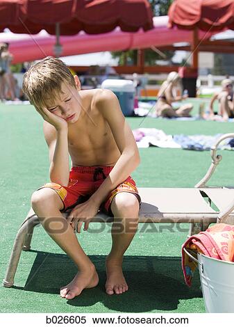 boy looking dejected at waterpark View Large Photo Image Stock Photography - boy looking dejected at waterpark. Fotosearch
