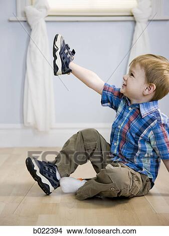 boy putting on shoes View Large Photo Image Picture - boy putting on shoes. Fotosearch