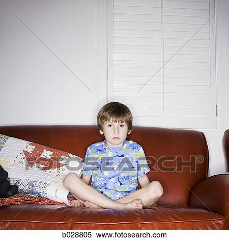 boy sitting on the couch watching television View Large Photo Image Stock Photography - boy sitting on the couch watching television. Fotosearch