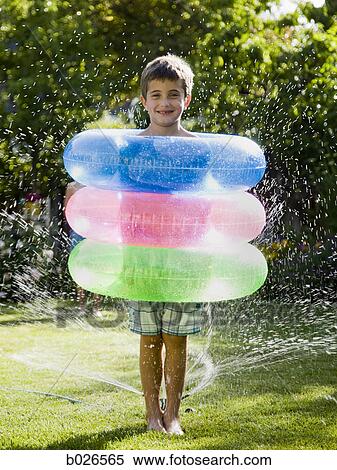 Stock Photography - boy with three inner tubes. Fotosearch