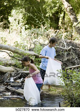 brother and sister cleaning up a river View Large Photo Image Stock Image - brother and sister cleaning up a river. Fotosearch