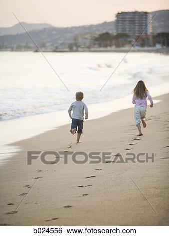 brother and sister running at the beach View Large Photo Image Stock Photograph - brother and sister running at the beach. Fotosearch
