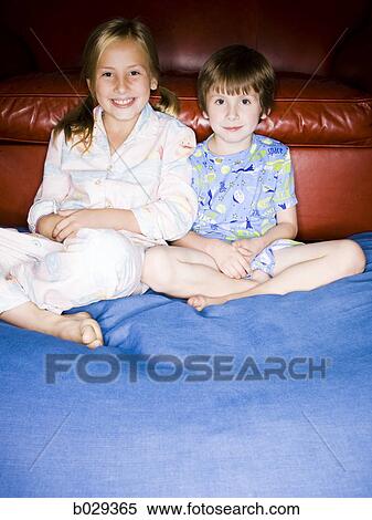 Stock Photography - brother and sister sitting on the floor. Fotosearch