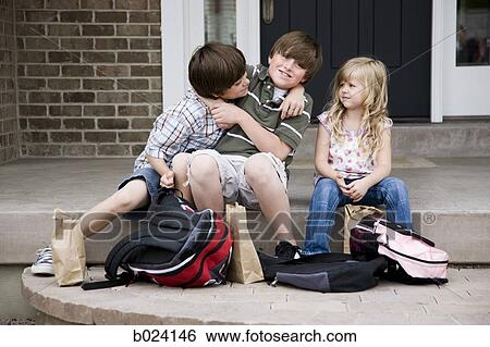 Stock Photograph - brothers fighting as little sister watches. Fotosearch
