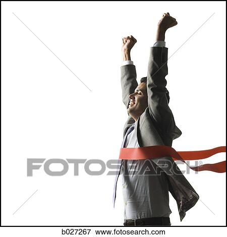 businessman crossing a finish line of a red ribbon with arms raised in the air triumphantly View Large Photo Image Stock Photo - businessman crossing a finish line of a red ribbon with arms raised in the air triumphantly. Fotosearch