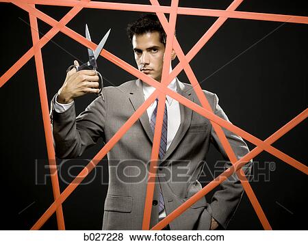 businessman cutting through the red tape View Large Photo Image Stock Photo - businessman cutting through the red tape. Fotosearch