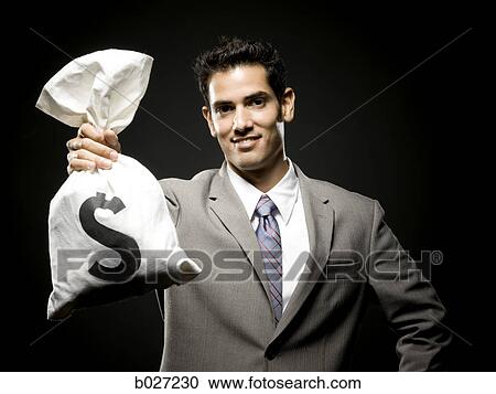 Stock Image - businessman holding a bag of money. Fotosearch